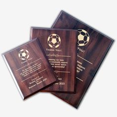 three wooden plaques with soccer balls on them