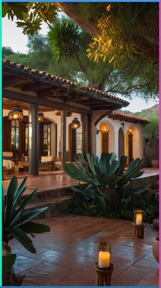 an outdoor patio with candles lit up in front of it