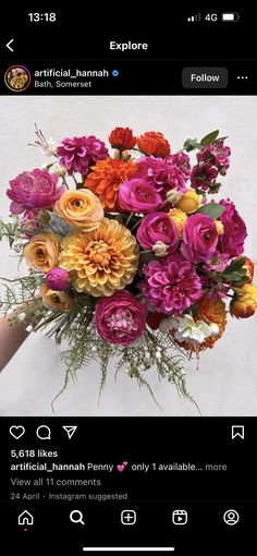 a person holding a bouquet of flowers in front of a white wall with an instagram message on it