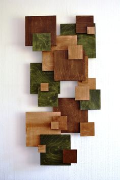 an art piece made out of wood with squares and rectangles on the wall