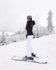 a woman standing on skis in the snow