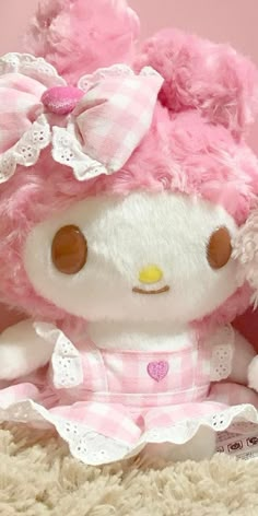 a hello kitty stuffed animal with pink hair