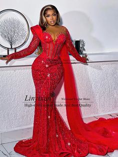 a woman in a red gown posing for the camera