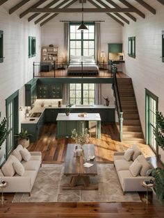 a living room filled with furniture next to a kitchen and dining area in a loft