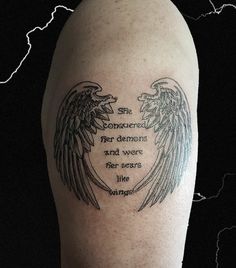 an arm with two angel wings on it and the words, she remembers her demons and was