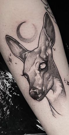 a black and white tattoo of a kangaroo