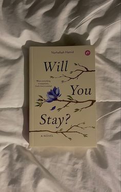 the book will you stay? is laying on a bed