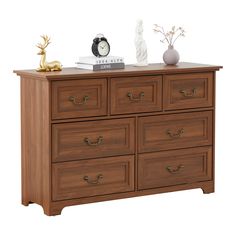 a wooden dresser with drawers and a clock on top