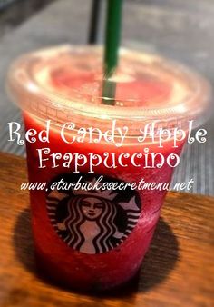 a red drink in a plastic cup with the words red candy apple frappuccino