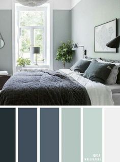 a bedroom with grey walls and white trim, gray bedding, blue pillows, green accents