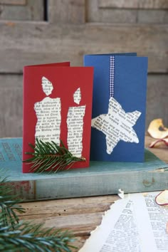 two christmas cards on top of a book