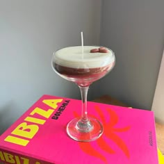 a drink sitting on top of a pink box