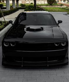 a black sports car parked in front of a building