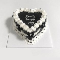 a heart - shaped cake with the words really happy day written on it in black and white frosting