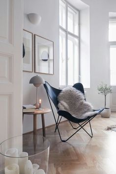 a living room filled with furniture and candles