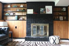 a living room with a fire place and bookshelves