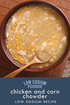 a bowl of chicken and corn chowder with a wooden spoon in it on a table