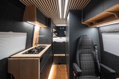 the interior of a small camper with a kitchen and living room area in it