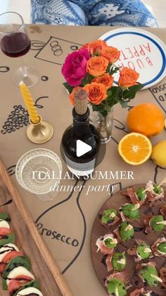 a table topped with food and drinks on top of a wooden tray next to oranges