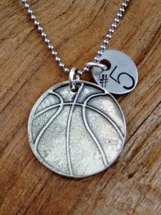 a silver necklace with a basketball on it