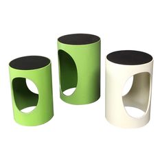 three green and white vases sitting next to each other