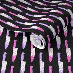 a black and pink wallpaper with many different colored knives on it's surface