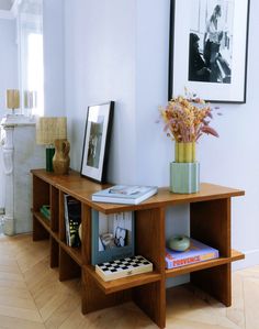 a wooden table topped with books and flowers