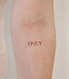 the word spicy written on someone's leg