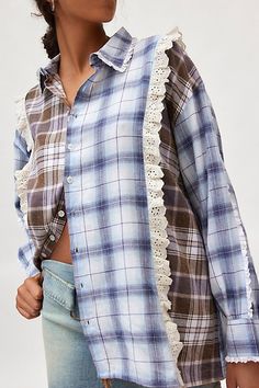 a woman wearing a blue and white plaid shirt with lace trims on the sleeves