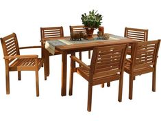 a wooden table with chairs around it and a potted plant on the table top