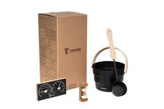 a black bucket and wooden spoon next to a cardboard box