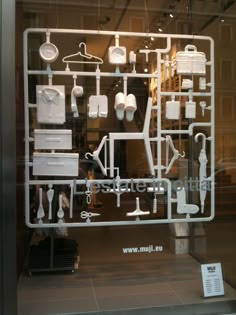 a display case with various items on it in a store front window that says,