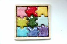 a colorful puzzle piece sitting on top of a white table