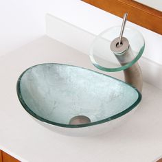 a bathroom sink with a glass bowl on the counter and a metal faucet