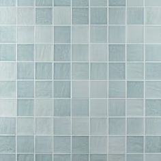 a white tiled wall with blue and gray tiles