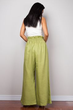 "Green Linen trousers, Handmade long wide leg palazzo pants with pockets. Green high waist women's summer linen pants, natural linen pants Made with the highest care this beautifully crafted high waist women's summer pants will fit you perfect thanks to the elastic strap on the waist and the added drawstring. I like wearing this one when sitting in the garden reading a book and dream away. Soul of the Orient Collection - Original Design & Produced by NUICHAN PRODUCT SIZE : * Waist : elastic Baggy Wide Leg Vacation Pants, Summer Ramie Bottoms, Linen Wide-leg Harem Pants With Pockets, Linen Harem Pants With Pockets, Green Linen Harem Pants With Elastic Waistband, Wide Leg Ramie Bottoms With Pockets, Relaxed Fit High-waisted Harem Pants For Summer, High-waisted Relaxed Fit Harem Pants For Summer, Summer High-waisted Relaxed Fit Harem Pants