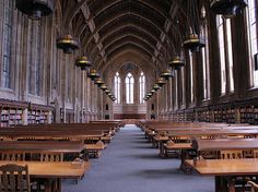 an empty library with rows of tables and chairs