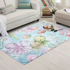 a living room with white couches and an ocean themed area rug on the floor