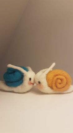 two small stuffed animals sitting next to each other