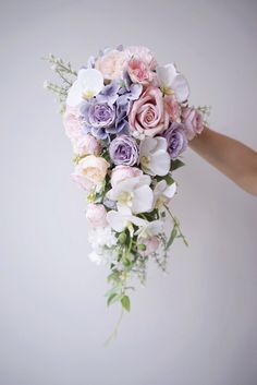 a person holding a bouquet of flowers in their hand