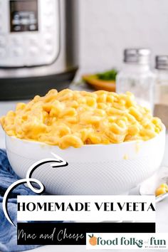 a bowl filled with macaroni and cheese next to an instant pressure cooker