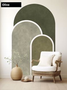 a white chair sitting in front of a wall with an arch design on it's side