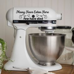 a white mixer sitting on top of a wooden table