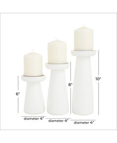 three white candles sitting next to each other on top of a wooden table with measurements