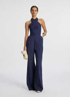 Front view of woman wearing navy blue sleeveless jumpsuit Blue Jumpsuits Outfit, Semi Formal Wedding Attire, Jumpsuit Outfit Wedding, Cocktail Wedding Attire, Cocktail Attire For Women, Jumpsuit For Wedding Guest, Raffia Clutch, Semi Formal Attire, Semi Formal Outfits