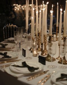 the table is set with candles and place settings for an elegant dinner or special event