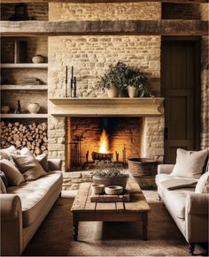 a living room filled with furniture and a fire place in the middle of a fireplace