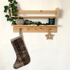 a christmas stocking hanging from a wooden shelf