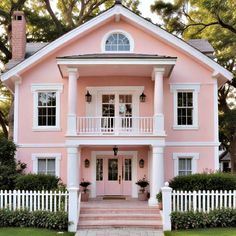 a pink house with white trim and windows