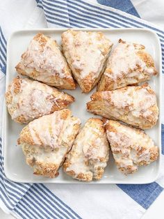 a white plate topped with pastries on top of a blue and white table cloth